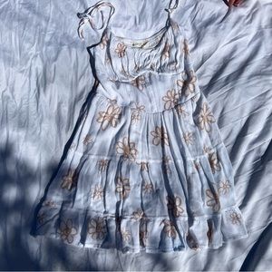 White mini dress with tan colored flower detailing